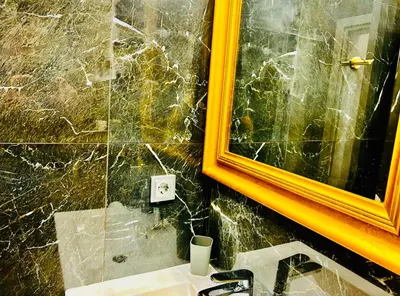 a bathroom with a sink and a mirror at PORT TWINS SUITES No1 in Piraeus