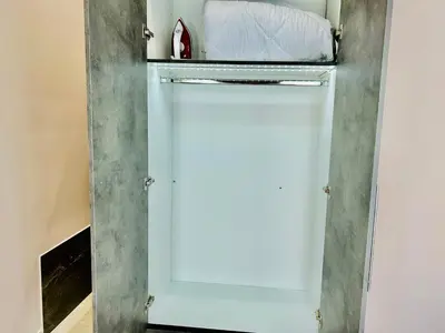 a white refrigerator with a door in a room at PORT TWINS SUITES No1 in Piraeus