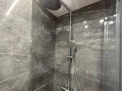 a shower with a glass door in a bathroom at PORT TWINS SUITES No1 in Piraeus