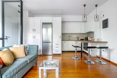 a living room with a couch and a table at Athena's South Apartment in Athens