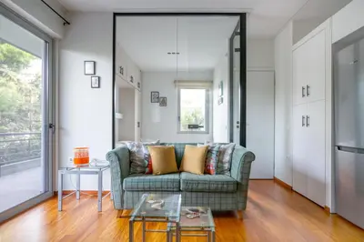 a living room with a couch and a table at Athena's South Apartment in Athens