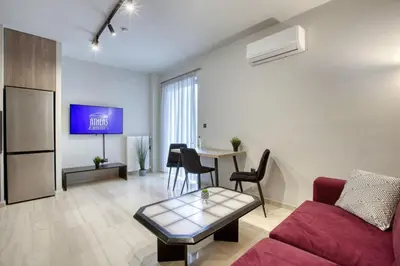 a living room with a couch and a table at Sweet and modern flat at Palaio faliro in Athens