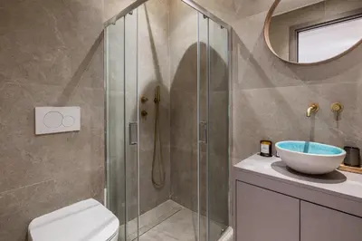 a bathroom with a shower with a toilet and a sink at Jun in Athens