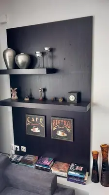 a shelf with some books and vases on it at The Beach House in Porto Rafti