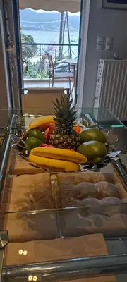 a glass table with a bunch of fruit on it at The Beach House in Porto Rafti