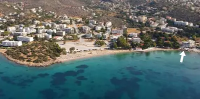 an island with a white arrow in the water at The Beach House in Porto Rafti