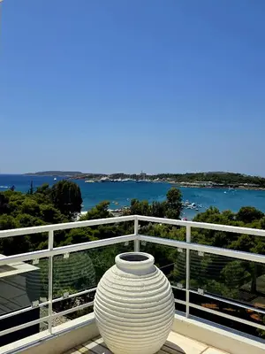 a large white vase sitting on top of a balcony at Luxury penthouse with stunning riviera view by GHH in Athens
