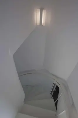 a white stairs with a light on top of it at Luxury penthouse with stunning riviera view by GHH in Athens