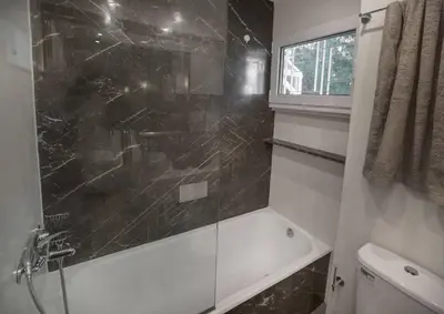 a bathroom with a shower and a tub and a toilet at Luxury penthouse with stunning riviera view by GHH in Athens
