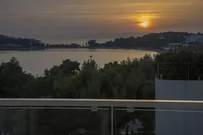 a view of a river with the sunset in the background at Luxury penthouse with stunning riviera view by GHH in Athens