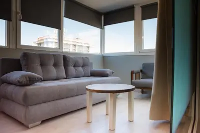 a living room with a couch and a table at 3C’s Athens South @Delta: SNFCC / Faliro Seaview Penthouse in Athens