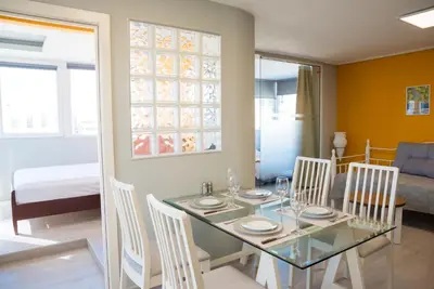 a dining room with a glass table and chairs at 3C’s Athens South @Delta: SNFCC / Faliro Seaview Penthouse in Athens