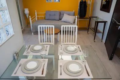 a table with plates and glasses on top of it at 3C’s Athens South @Delta: SNFCC / Faliro Seaview Penthouse in Athens