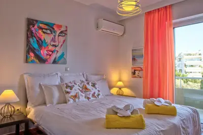 a bedroom with a bed with two towels on it at Beautiful apartment in Glyfada center in Athens