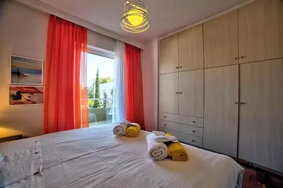 a bedroom with a bed with towels on it at Beautiful apartment in Glyfada center in Athens