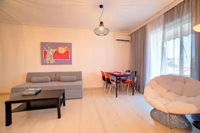 a living room with a couch and a table at Beautiful apartment in Glyfada center in Athens