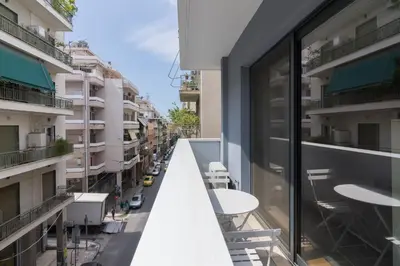 an empty balcony of a building with tables and chairs at Athens Trikoupi Suite D1 in Athens