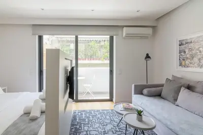 a living room with a couch and a table at Athens Trikoupi Suite D1 in Athens