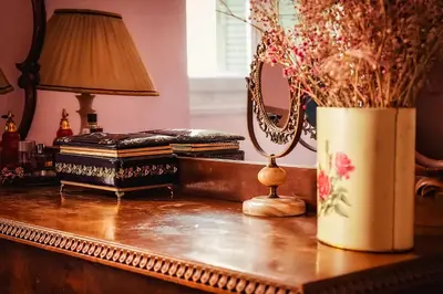 a table with a mirror and a vase of flowers at Athens Quinta in Athens