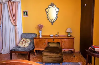 a room with a desk and a chair and a mirror at Athens Quinta in Athens