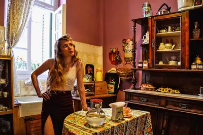 a woman standing in front of a table in a room at Athens Quinta in Athens