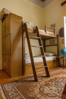 a bunk bed with a ladder in a room at Athens Quinta in Athens
