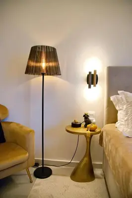 a room with a table and a lamp and a bed at Suites Rania in Áyios Yeóryios