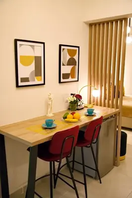 a kitchen with a table and chairs with fruit on it at Suites Rania in Áyios Yeóryios