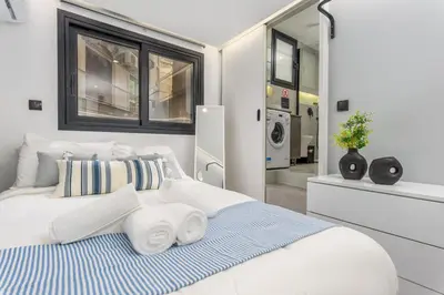 a bedroom with a bed with towels on it at The Oh Boy Studio in Athens in Athens
