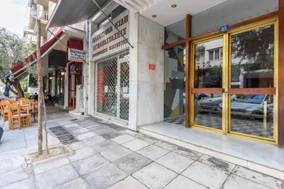 a store front with glass doors on a city street at The Oh Boy Studio in Athens in Athens
