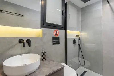 a bathroom with a white sink and a shower at The Oh Boy Studio in Athens in Athens