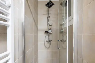 a bathroom with a shower with a glass door at Theia 1-Bedroom Apartment in Athens in Athens