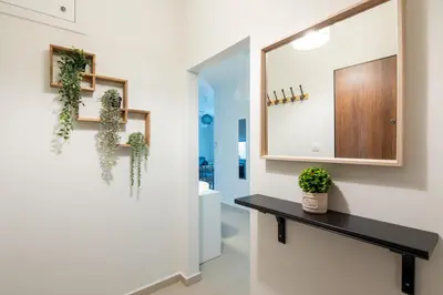 a bathroom with a mirror and plants on the wall at Theia 1-Bedroom Apartment in Athens in Athens