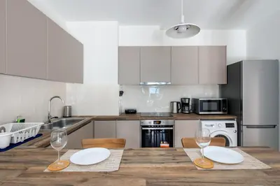 a kitchen with a wooden table with two wine glasses at Astrea 1- Bedroom Apartment in Athens in Athens