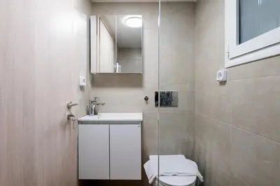 a bathroom with a toilet and a sink and a mirror at Astrea 1- Bedroom Apartment in Athens in Athens