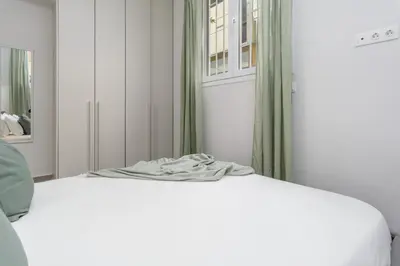 a white bed in a room with a window at Penelope Charming 2Bedroom Apartment in Athens in Athens