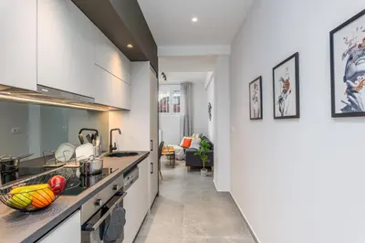 a kitchen with white cabinets and a counter top at Penelope Charming 2Bedroom Apartment in Athens in Athens