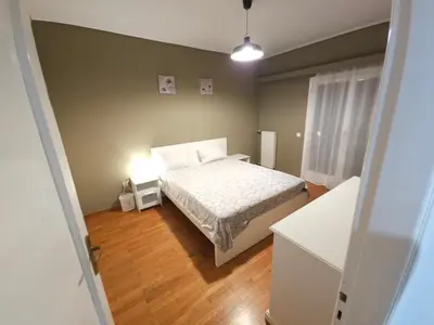 a small bedroom with a bed and a lamp at Luxurious Palace Marina Alimos in Athens