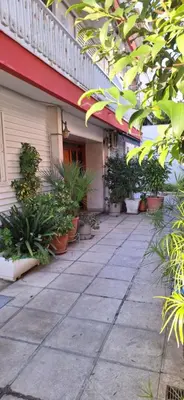 a courtyard with potted plants on the side of a building at Luxurious Palace Marina Alimos in Athens