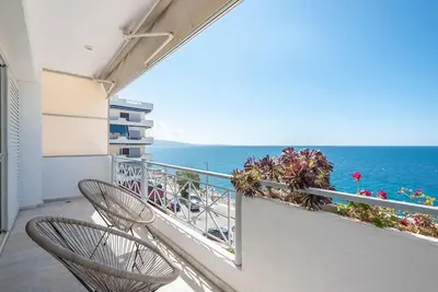 two chairs on a balcony looking out at the ocean at Calipso in Piraeus