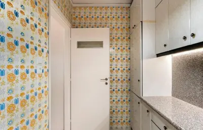 a kitchen with a white door and a tile wall at Seaside Beauty 5 min Vouliagmeni Beach in Athens