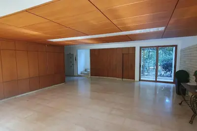 a large empty room with a wooden ceiling at Seaside Beauty 5 min Vouliagmeni Beach in Athens