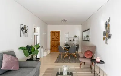 a living room with a couch and a table at Seaside Beauty 5 min Vouliagmeni Beach in Athens