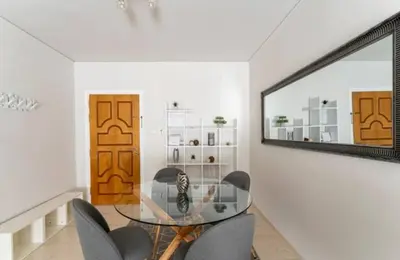 a dining room with a glass table and a mirror at Seaside Beauty 5 min Vouliagmeni Beach in Athens