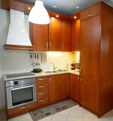 a kitchen with wooden cabinets and a sink at Aqua Apartment Kallithea Athens in Athens