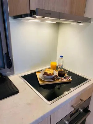 a table with a plate of food and a glass of orange juice at NEW 2BD APRT with SHARED ROOFTOP POOL E2 in Athens