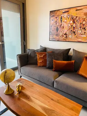 a living room with a couch and a wooden table at NEW 2BD APRT with SHARED ROOFTOP POOL E2 in Athens