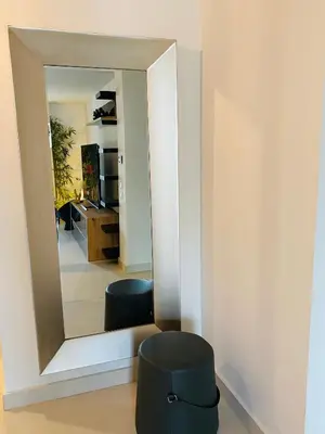a mirror in a room with a stool and a sink at NEW 2BD APRT with SHARED ROOFTOP POOL E2 in Athens