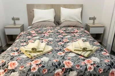 a bed with two books and flowers on it at The Golden home 1 in Piraeus