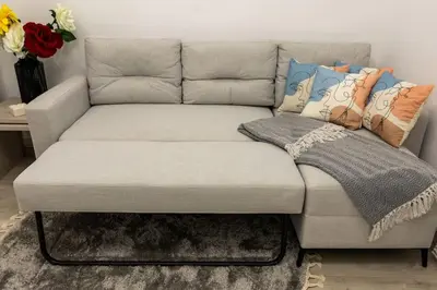 a couch with pillows on it in a living room at The Golden home 1 in Piraeus